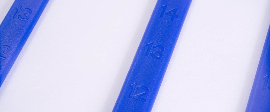 Numerical markings at regular intervals along the strap allows for cutting of the strap without losing integrity.